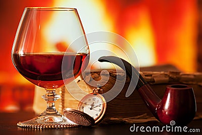 Brandy, book, smoking pipe and pocket watch Stock Photo