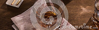 Brandy glasses with map and matches on wooden table, panoramic shot Stock Photo