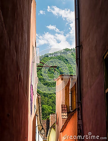 Brasov written with big letters on Mount Tampa. Brasov sign seen from the narrow streets of the old town Editorial Stock Photo