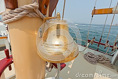 Brass bell on the private sail yacht. Stock Photo