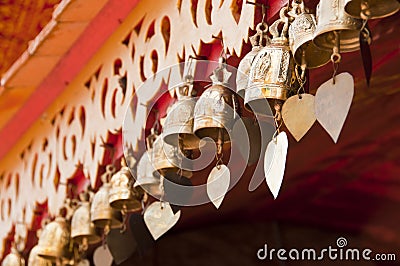 Brass bell on temple corridor ceiling. Stock Photo