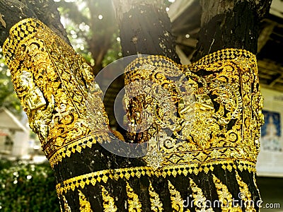 Brass plate carved in Thai style on a tree Stock Photo