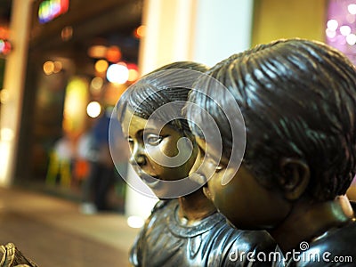 Brass Statue of Little Boy and Girl Editorial Stock Photo