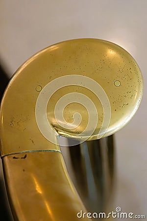 Brass volute newel at bottom of staircase against white, vertical Stock Photo