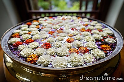 Brass water basin filled with carnations Stock Photo