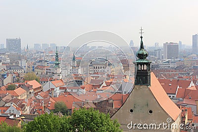 Bratislava, Slovakia - April, 2011: green trees, Temple of St. Nicholas and old city view from hill of Bratislava Castle in cloudy Editorial Stock Photo
