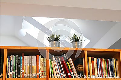 Last shelf with books in Slovak under the ceiling in the library of monastery of the Sisters of the Most Holy Savior, Bratislava Editorial Stock Photo