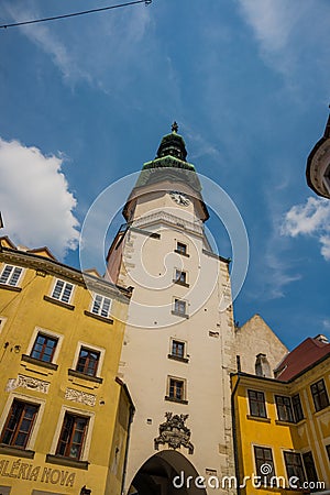 Bratislava, Slovakia: City street daily view of the historical buildings and the famous St. Michael`s Gate and Tower in the Stock Photo