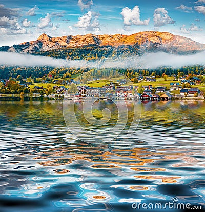 Brauhof village reflected in calm waters of Grundlsee lake. Stock Photo