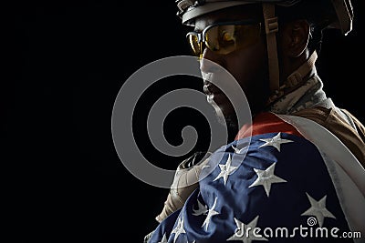 Brave African soldier posing with national flag. Stock Photo