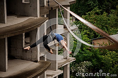 Brave blonde woman balancing on a slackline Stock Photo