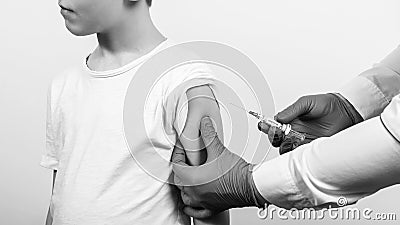 Brave child receiving injection or vaccine. Vaccination and prevention against flu or virus. Covid-19 vaccine Stock Photo