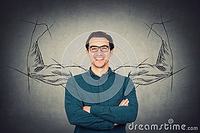 Brave and confident guy keeps arms folded, strong personality, has no fears. Business person wears eyeglasses, powerful hero Stock Photo