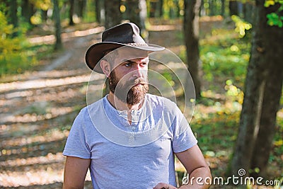 Brave cowboy. camping and hiking. mature male with brutal look. Bearded man in cowboy hat walk in park outdoor. man Stock Photo