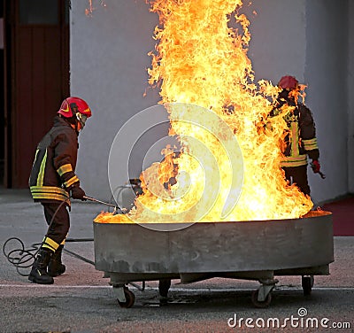 Brave firefighters during the test of a fire extinguishing Stock Photo