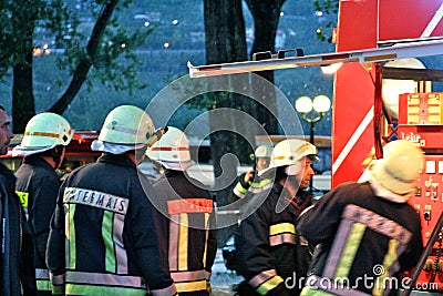 Brave firefighters with the truck and fire hydrants in operation Editorial Stock Photo