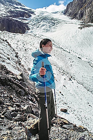 Brave girl conquering mountain peaks of the Altai mountains. The majestic nature of the mountain peaks and lakes. Hiking Stock Photo