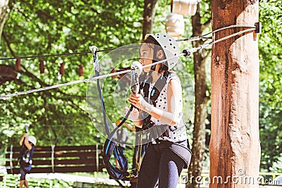 Brave little girl in the forest adventure park Stock Photo