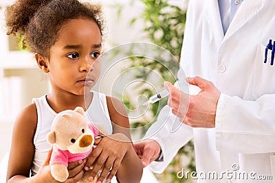 Brave little girl receiving injection Stock Photo