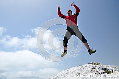 Brave man jumping from a cliff Stock Photo