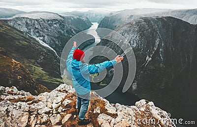 Brave traveler man raised hands traveling in Norway Stock Photo