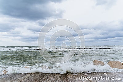 Brave waves of the Adriatic sea beating against the breakwater of the seafront in Bari, Italy Stock Photo