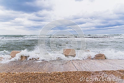 Brave waves of the Adriatic sea beating against the breakwater of the seafront in Bari, Italy Stock Photo