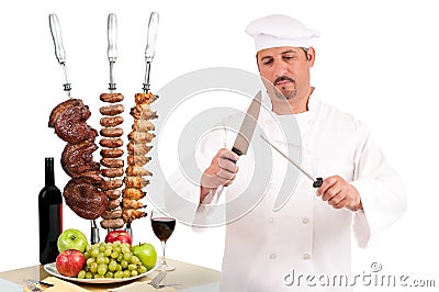 Chef preparing steak, sausage and chicken Stock Photo