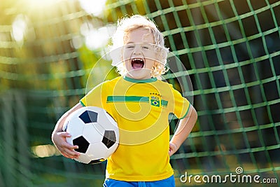 Brazil football fan kids. Children play soccer. Stock Photo