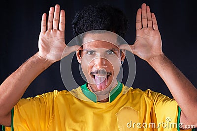 Brazilian Soccer Black Player Fan With Yellow Shirt Celebrating Stock Photo