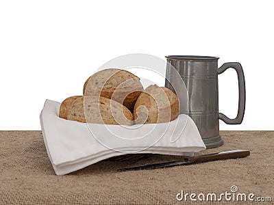 Bread and ale, rustic lunch, with old pewter tankard, bread rolls and knife. Still life. Stock Photo