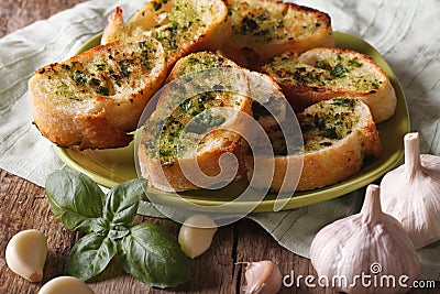 Bread with basil and garlic closeup on plate. Horizontal Stock Photo