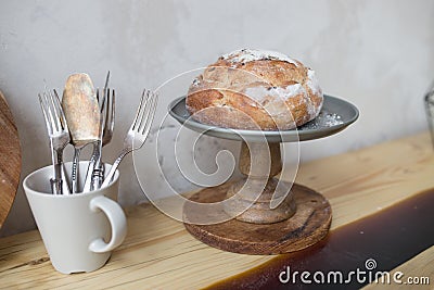Bread in the basket. loaf and baguette in the kitchen, homemade pastries with powder. delicious flour products Stock Photo