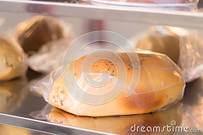 Bread covered in plastic on a shelf Stock Photo