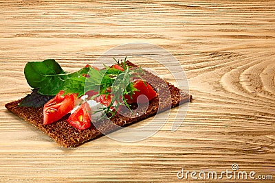 Bread crisp with tomato, cheese and arugula Stock Photo