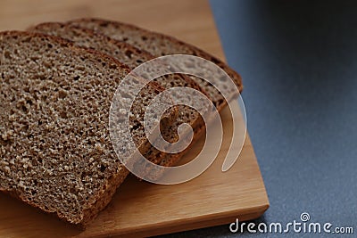 Bread, health, diet, slice up, natural nutrition. Slices of homemade bread on the wooden board. Dark bread Stock Photo