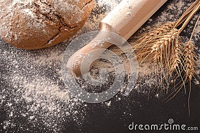 Loaf homemade with kneader at the top on black table Stock Photo