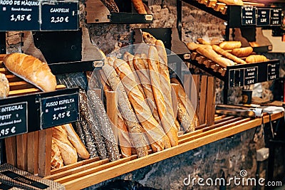 Bread shop showcase. Various loaves of bread on the shelves in the store. Stock Photo
