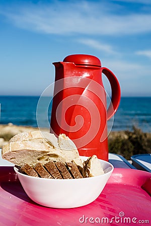 Bread slices and thermos on beach Stock Photo