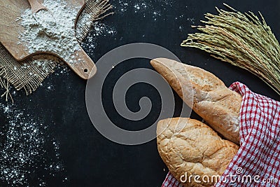 Bread , wheat and flour on black chalkboard , bakery background Stock Photo