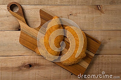 Breaded chicken filet, on a wooden background. top wiew Stock Photo