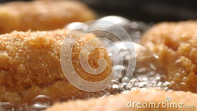 Breaded Cutlets Sizzle in Frying Pan. Stock Photo