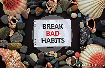 Break bad habits symbol. Words `Break bad habits` on white note, black background. Sea stones and seashells. Business, psycholog Stock Photo