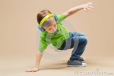 break dance kids. little break dancer showing his skills in dance studio. Hip hop dancer boy performing over studio background Stock Photo