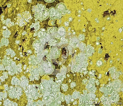 Breakdown, cracking and flaking of rusty yellow metal surface Stock Photo