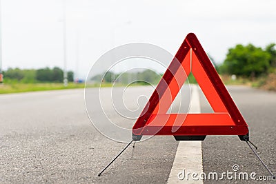 Breakdown triangle stands alongside the road. Broken car sign on a road concept Stock Photo