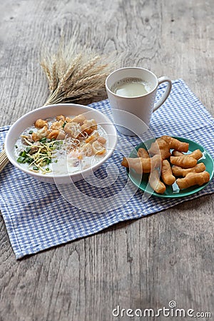 Breakfase meal. Congee or Rice porridge minced pork, boiled egg with soy milk and Chinese deep fried double dough stick Stock Photo