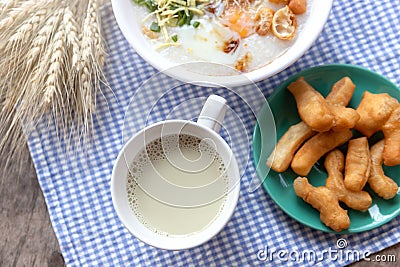 Breakfase meal. Congee or Rice porridge minced pork, boiled egg with soy milk and Chinese deep fried double dough stick Stock Photo