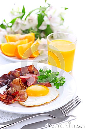 Breakfast with bacon, fried egg and orange juice Stock Photo