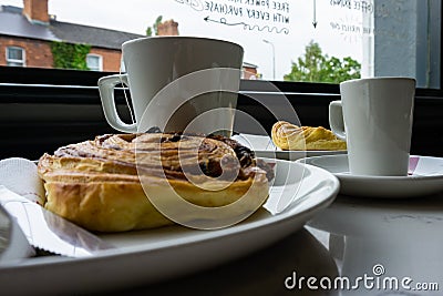 Breakfast at the bar with tea, coffee and Danish Stock Photo